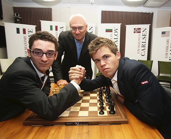 Reigning chess world champion Magnus Carlsen, right, from Norway, plays  Italian-American challenger Fabiano Caruana in the first five minutes of  round three of their World Chess Championship Match in London, Monday, Nov.