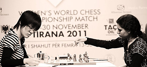 Humpy (right) on the move against Hou Yifan. Photo by Anastasiya Karlovich for FIDE.