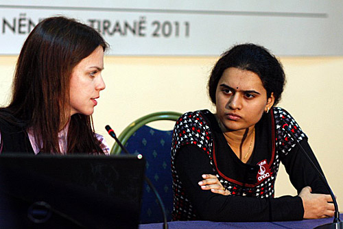 Humpy (right) on the move against Hou Yifan. Photo by Anastasiya Karlovich for FIDE.