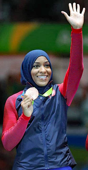 U.S. fencer Ibtihaj Muhammad received wide acclaim for wearing the hijab during the 2016 Olympics in Rio, where she won a bronze medal. Some Muslim women see coverings as a source of liberation from beauty objectification. Photo by Jason Getz (USA Today Sports)