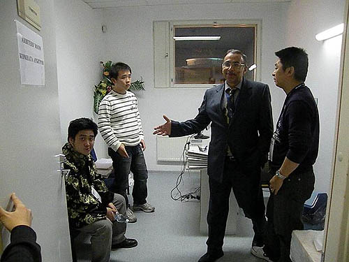 A dejected Wang Yue (seated) and Li Chao in arbiter's room after being assessed a forfeit for the second rapid game. Zhou Jianchao discusses situation with arbiter.