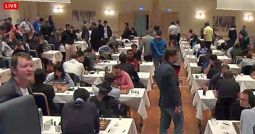 Bwalya in action against Kramnik with his signature Fedora hat.