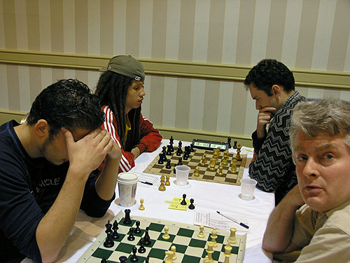 Kassa Korley playing Eugene Perelshteyn for an IM norm. GM Sergey Kudrin glances at camera.