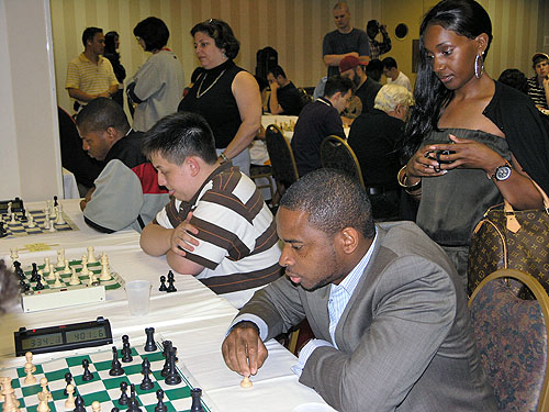 Chikwere Onyekwere at blitz tournament with his striking friend watching intently.