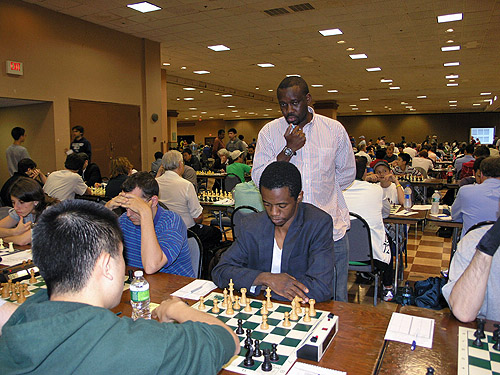 FM Victor Shen vs. IM-elect Farai Mandizha at 2010 World Open. Nigeria's IM Oladapo Adu watching the action. Shen won the section with a remarkable 8/9. Mandizha scored 7½ (losing only to Shen) and Adu tied for 3rd-5th with 7.