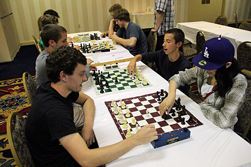 Bughouse happening! Nolan Hendrickson & partner vs. Megan Lee & Sasha Velikanov. Photo by Daaim Shabazz.