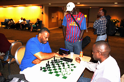 Oladapo Adu blitzing with Herb Carswell with Kamanyola Bior looking on. Photo by Daaim Shabazz.