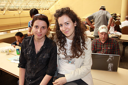 Iryna Zenyuk and Irina Krush with Alexander Shabalov in the background.  Photo by Daaim Shabazz.