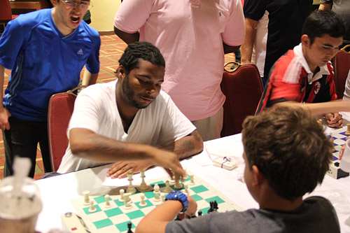 Tavon Carter, blitz extraordanaire playing blitz phenom and triathlete Hans Moke Niemann. Photo by Daaim Shabazz.