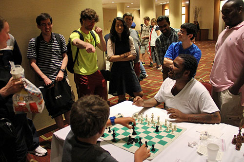 Tavon Carter, blitz extraordanaire playing blitz phenom and triathlete Hans Moke Niemann. Photo by Daaim Shabazz.