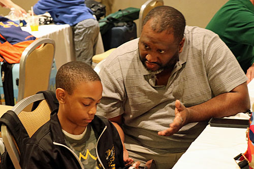 THE RIGHT WAY... Coach Tyrell Harriott giving words of wisdom to his player, Isiah. Photos by Daaim Shabazz/The Chess Drum